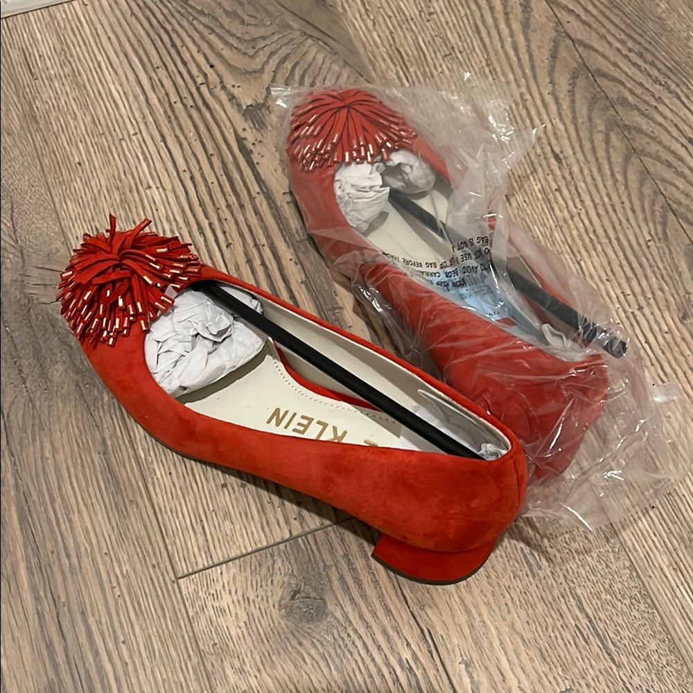 Calvin Klein Red Flats with Tassel Embellishments